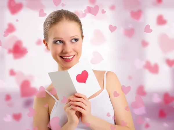 Beautiful girl reads a postcard valentine — Stock Photo, Image