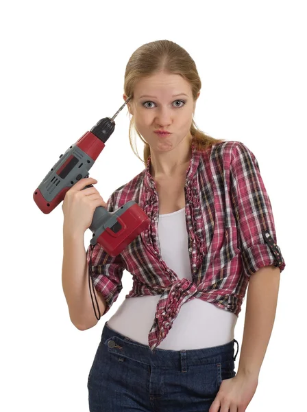 Funny beautiful young woman with a drill drills head — Stock Photo, Image