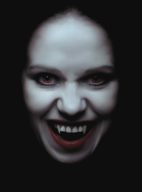 Woman vampire with fangs on a black background clipart