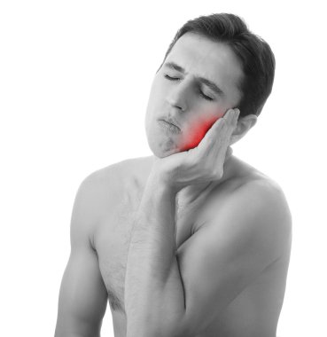 Young man holding his aching tooth in pain, isolated on white ba clipart