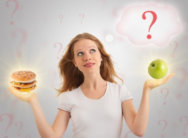 Attractive girl makes a choice between healthy and unhealthy foo clipart