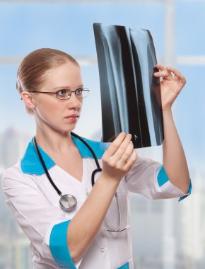 Woman doctor holding an x ray clipart