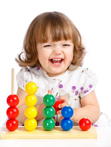 Liten flicka leker med bollar — Stockfoto