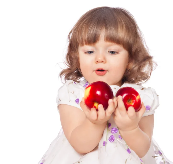 Portrait of a little girl eating apples — Stock Photo, Image