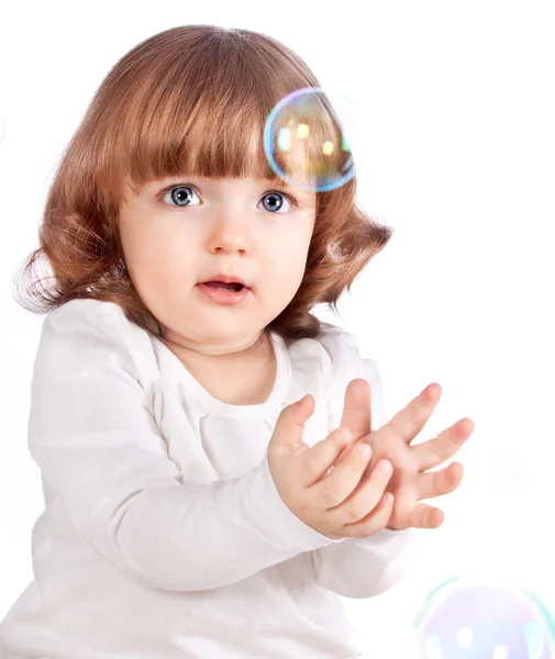 Girl catches the bubbles — Stock Photo, Image