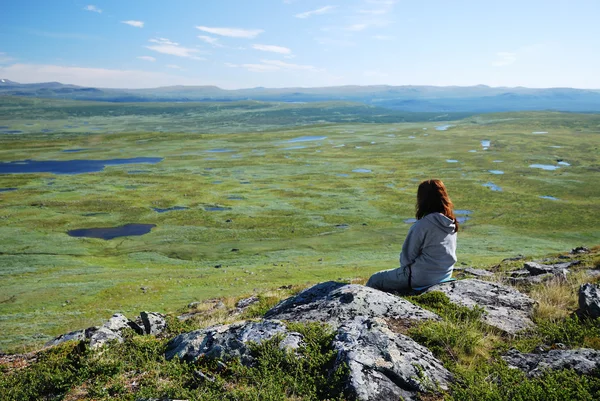 Woman against the green tableland with many small lakes. — Stock Photo, Image