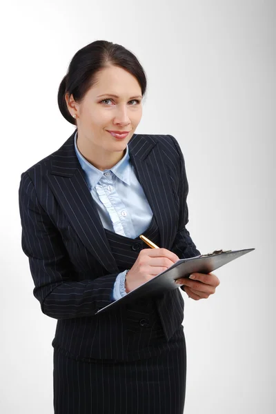 Attentive office worker writing in the folder. — Stock Photo, Image