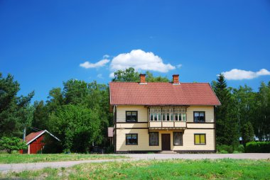 Swedish house in the middle of nature clipart