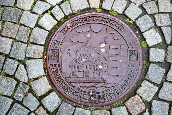 Sewer manhole on stone pavement of Trondheim. — Stock Photo, Image