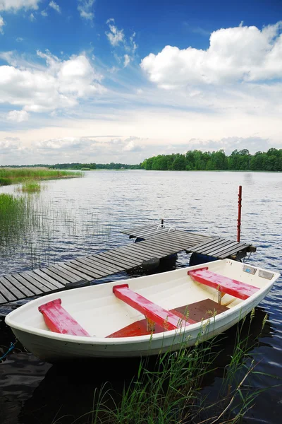 Swedish lake with small wooden wharf and boat — Stock Photo, Image