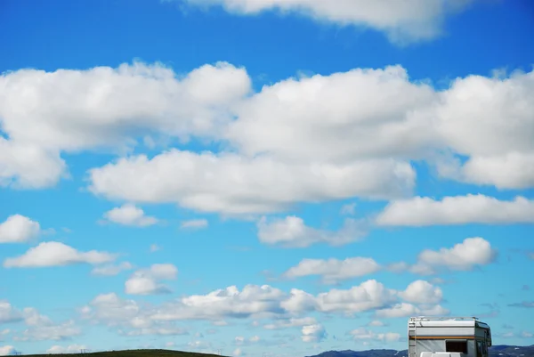 The sky with clouds and travel trailer — Stock Photo, Image