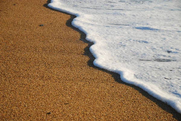 Close-up of sand beach with the foamy wave — Stock Photo, Image