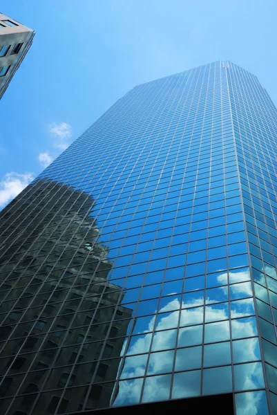 stock image Tower of skyscraper with reflection of cloud and building