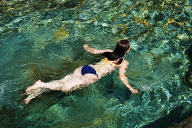 Woman in the clear water. clipart