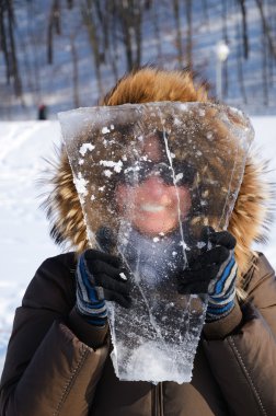 Woman with piece of ice. clipart