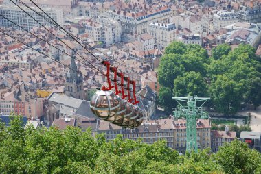 Cable cars over the city Grenoble. clipart