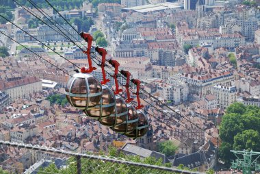 Cable cars over the city Grenoble. clipart