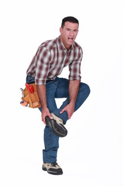 Builder with foot injury clipart