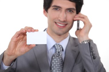 Businessman showing business card clipart