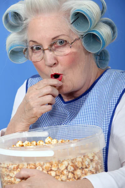 Babička jíst karamelový popcorn — Stock fotografie