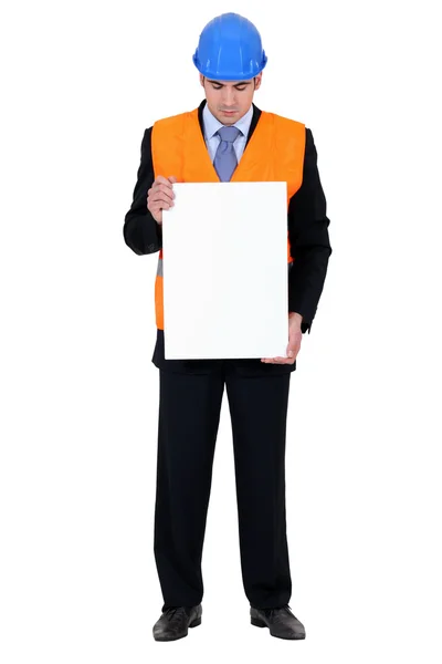 Man with helmet holding poster — Stock Photo, Image