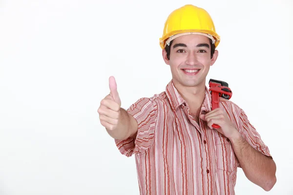 Polegares acima de um jovem trabalhador da construção civil — Fotografia de Stock