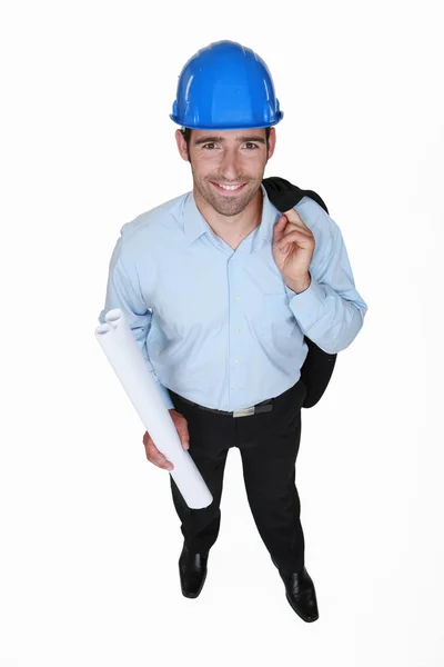 Smiling engineer holding a rolled-up drawing — Stock Photo, Image