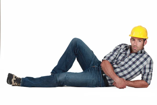 Attractive construction worker lying down — Stock Photo, Image