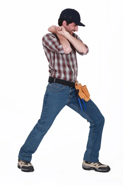 Handyman pulling an invisible object — Stock Photo, Image