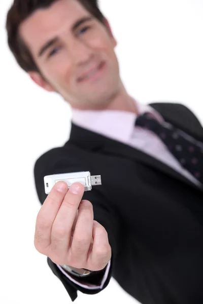 Businessman holding a memory stick — Stock Photo, Image