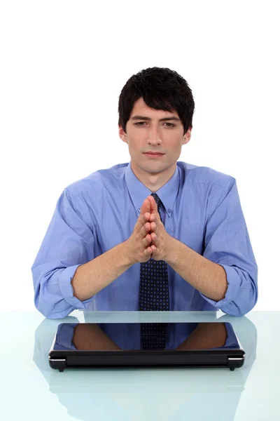 Businessman praying at desk — Stock Photo, Image