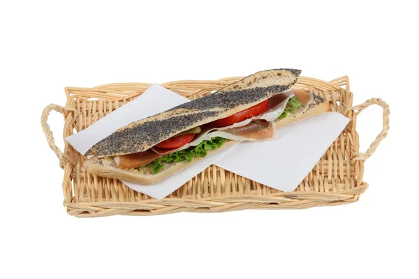 Long sandwich served on wicker tray — Stock Photo, Image