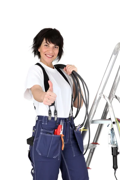 Mujer electricista dando los pulgares hacia arriba —  Fotos de Stock