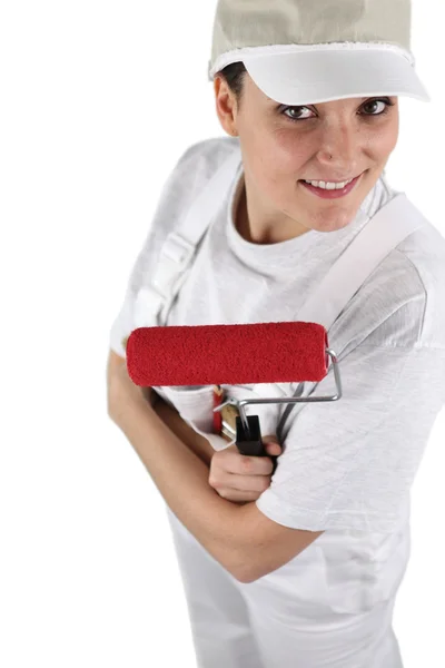 Female decorator with a red roller — Stock Photo, Image