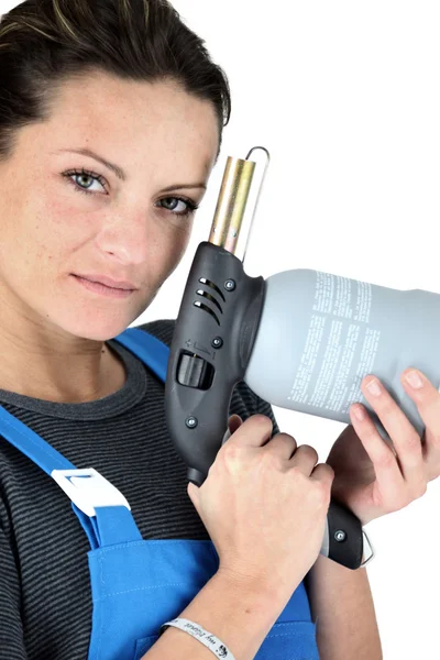 Woman with a blowtorch — Stock Photo, Image