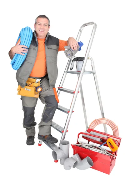 Man with ladder and plumbing tools — Stock Photo, Image
