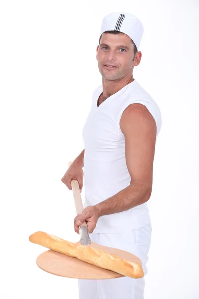 Bakery worker with fresh bread — Stock Photo, Image