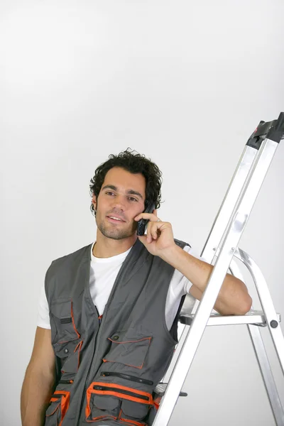 Man with a phone and stepladder Royalty Free Stock Photos