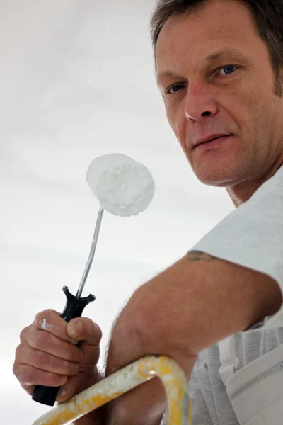 Closeup portrait of mature painter holding roller Royalty Free Stock Photos