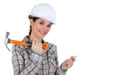 Tradeswoman holding a nail and hammer clipart