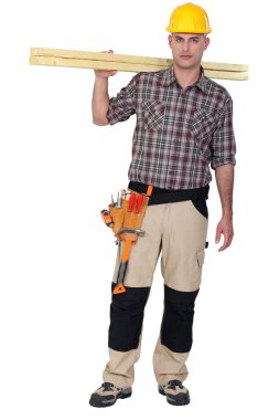 Man carrying two wooden plans over shoulder clipart