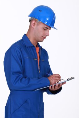 A construction worker taking notes. clipart