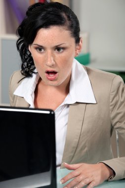 Shocked woman reading an e-mail clipart