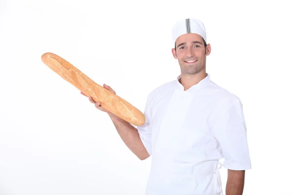 Baker holding baget — Stok fotoğraf