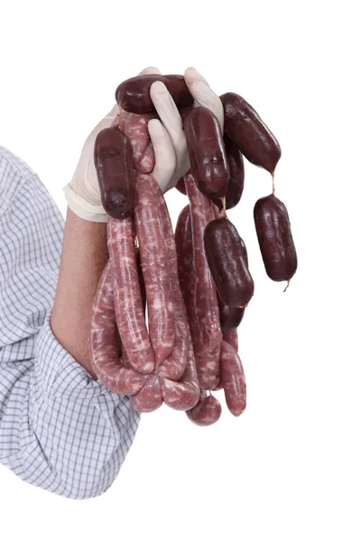 Butcher holding raw sausages — Stock Photo, Image