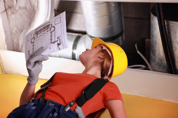 Women with a sketch of industrial facility — Stock Photo, Image
