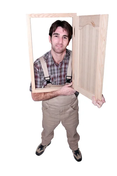 Carpenter with a cupboard door — Stock Photo, Image