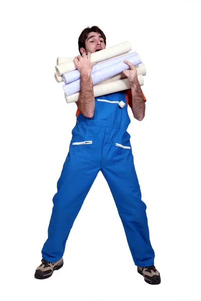 Man laden with rolls of wallpaper — Stock Photo, Image