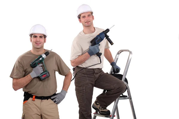 Obreros sosteniendo sus destornilladores eléctricos —  Fotos de Stock