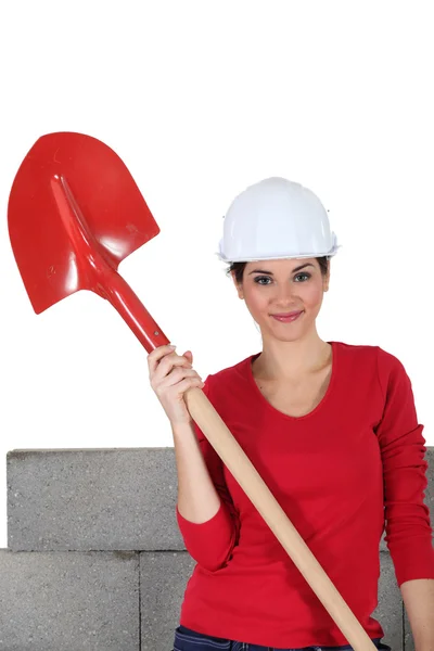 Sexy craftswoman holding a shovel — Stock Photo, Image